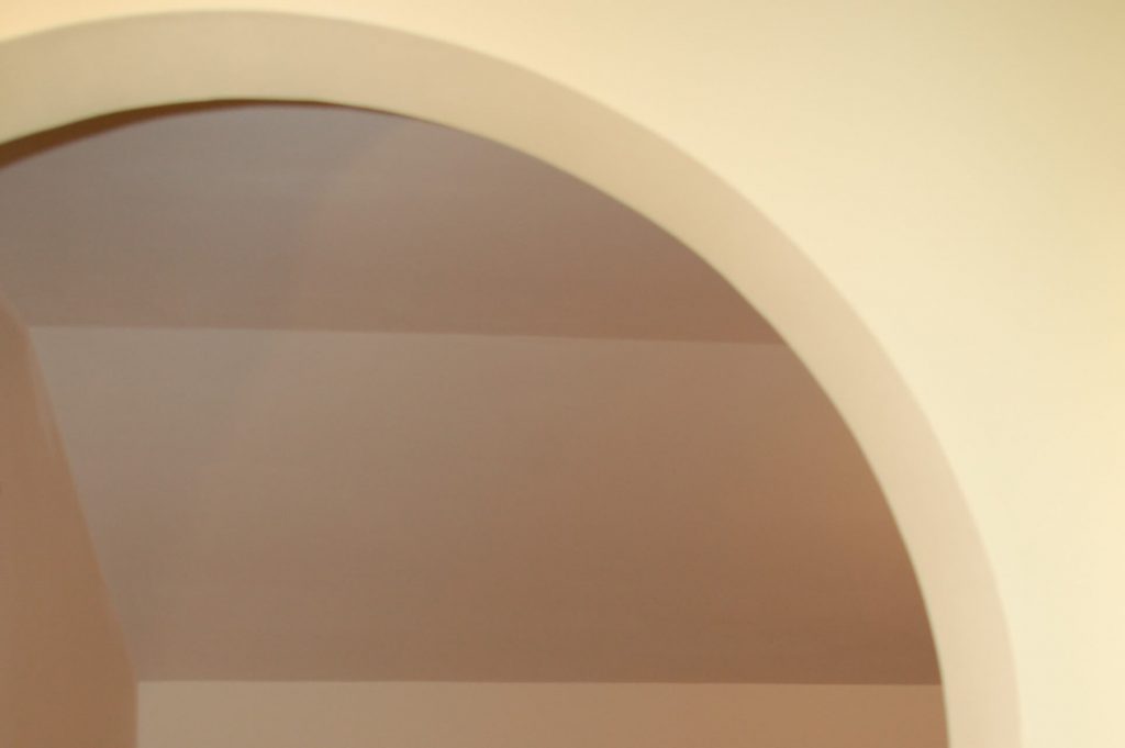 Walls are painted soft butter yellow; the ceiling is neutral mineral white